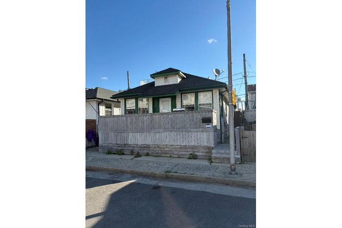 View of front of property with a shingled roof