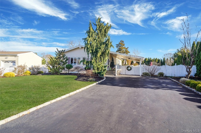 View of front of property with asphalt driveway