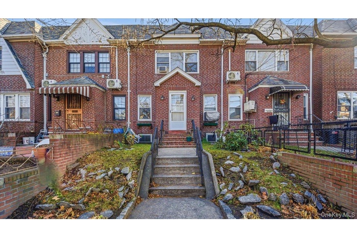 View of front facade with brick siding and roof with shingles