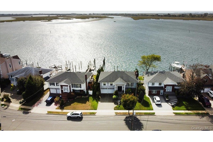 Aerial perspective of suburban area featuring a nearby body of water