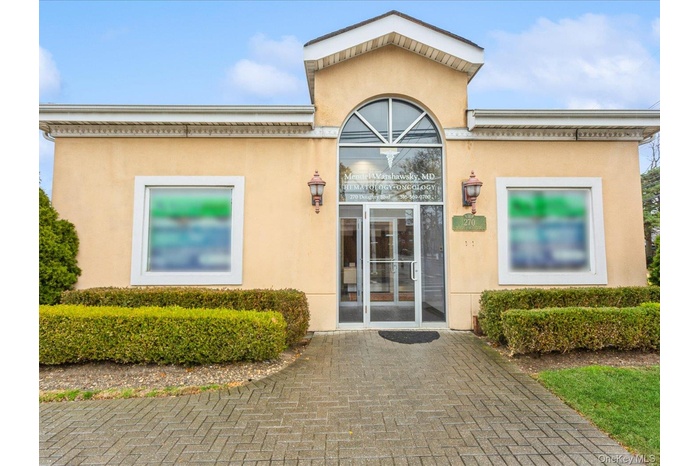 View of exterior entry with stucco siding