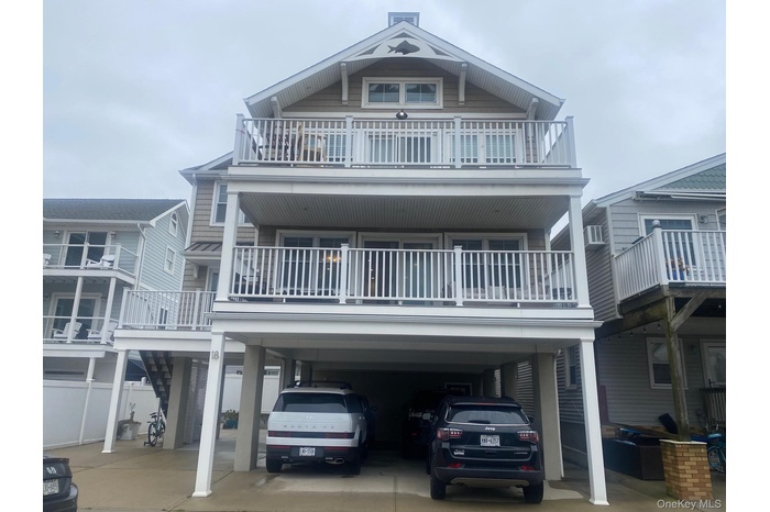 Coastal home with a carport and concrete driveway, for 2 cars