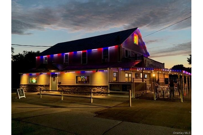 View of building exterior featuring a fenced front yard
