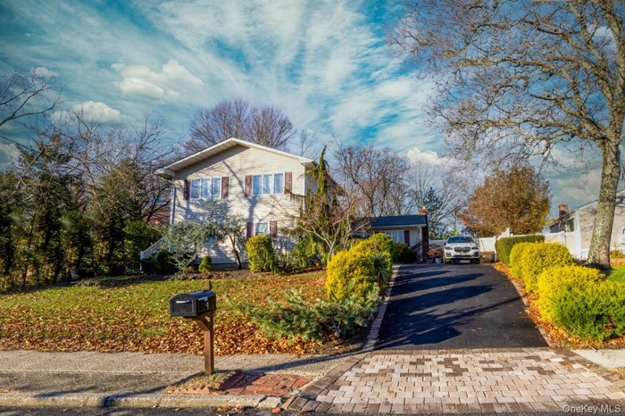 View of front facade with asphalt driveway