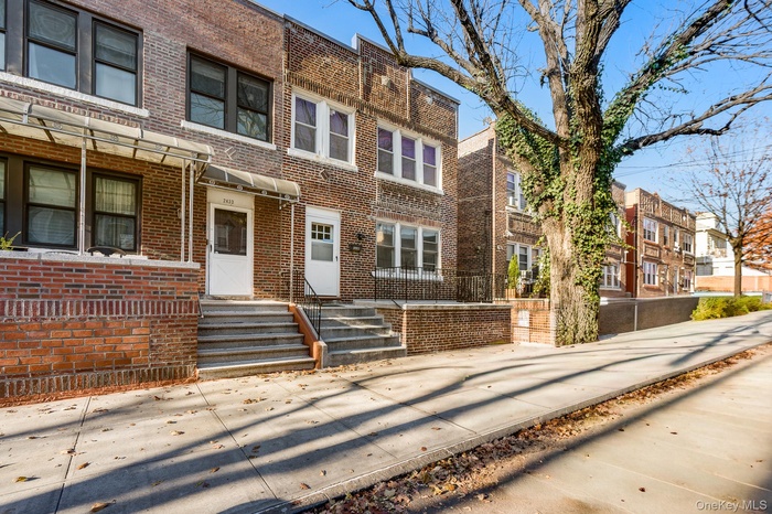 Traditional home featuring brick siding and a residential view