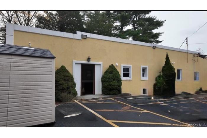 View of property with uncovered parking