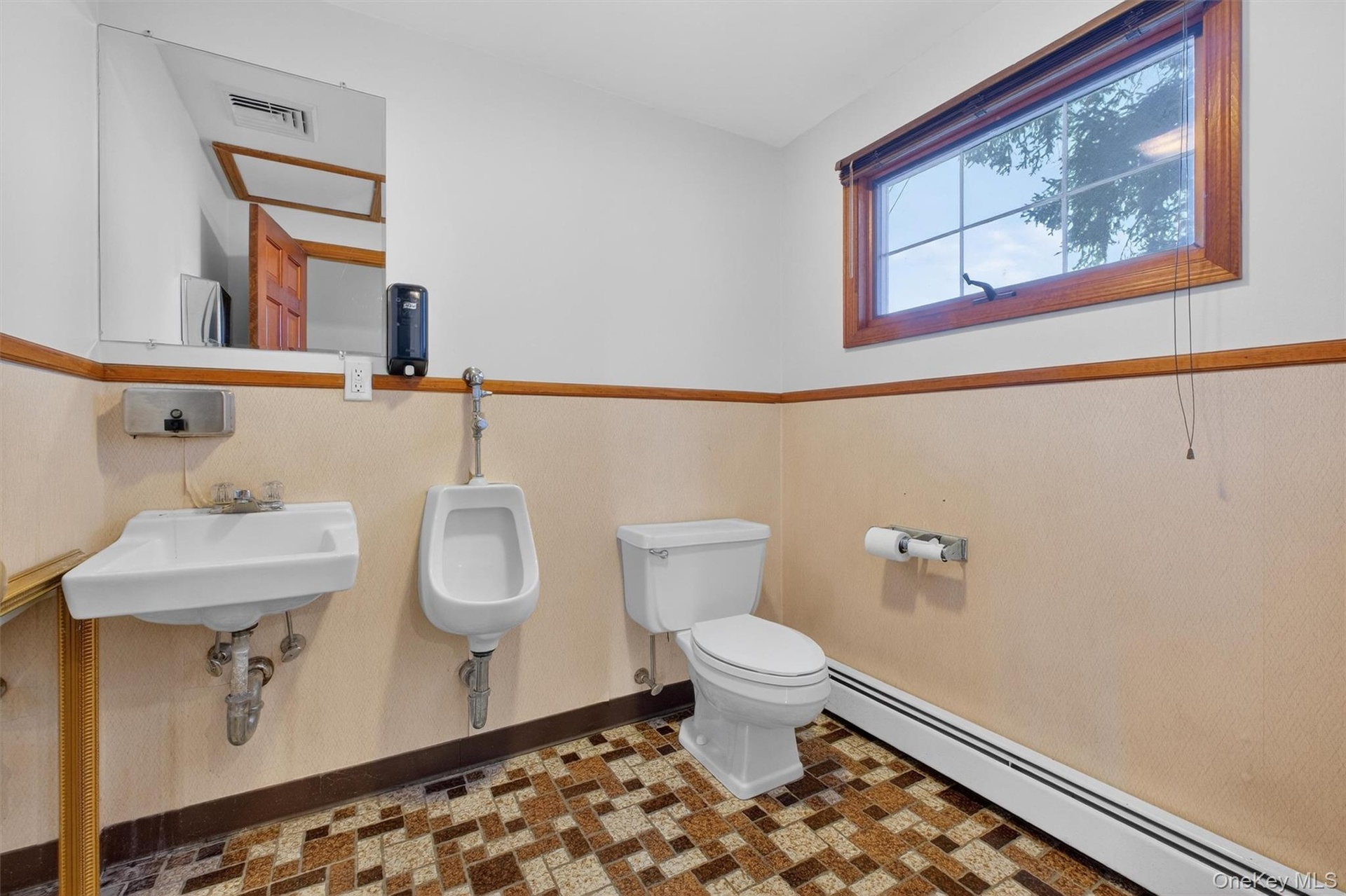 Bathroom with baseboard heating and toilet