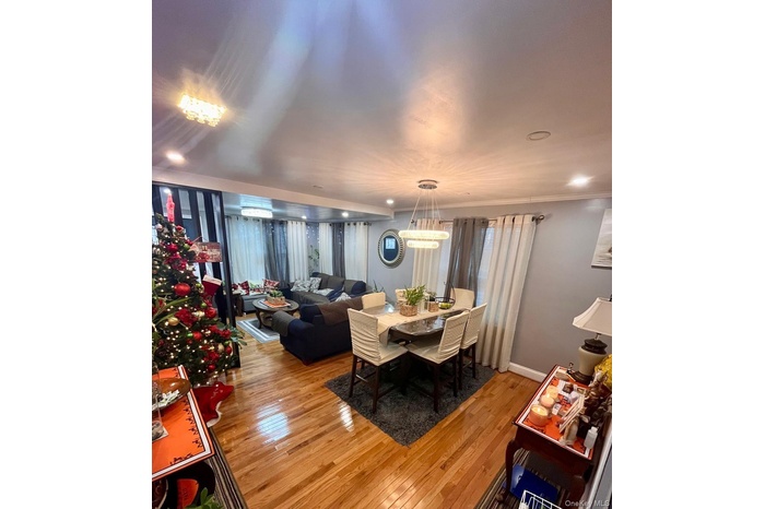 Dining area with wood-type flooring, recessed lighting, and ornamental molding