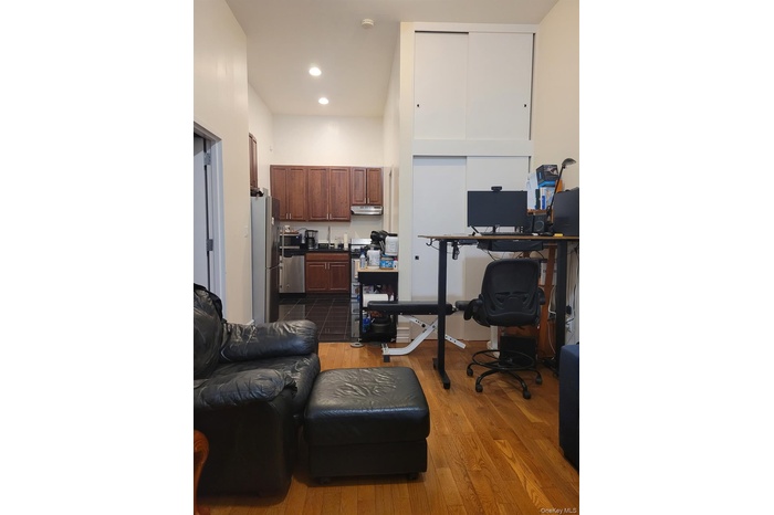 Home office featuring dark wood-style floors and recessed lighting