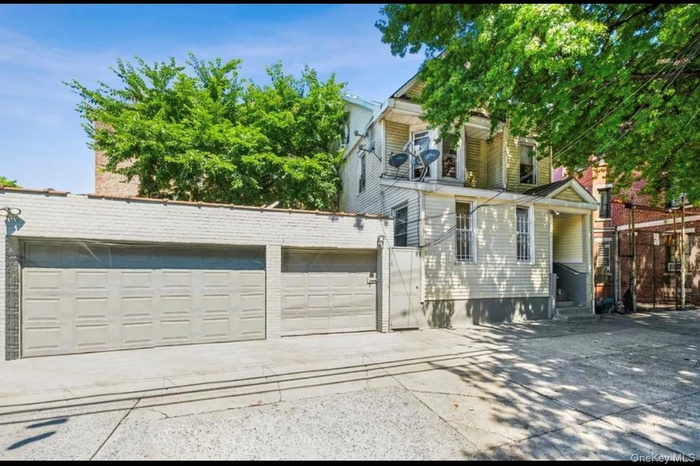 View of front of home featuring concrete driveway, a garage, and entry steps