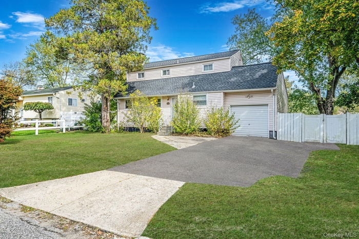 Traditional-style home featuring asphalt driveway
