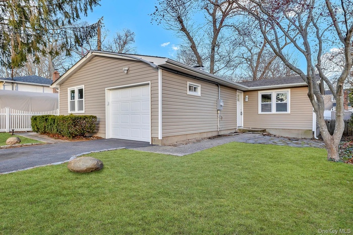 View of front of home with asphalt driveway