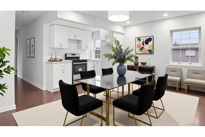 Dining space featuring dark wood-style flooring and recessed lighting
