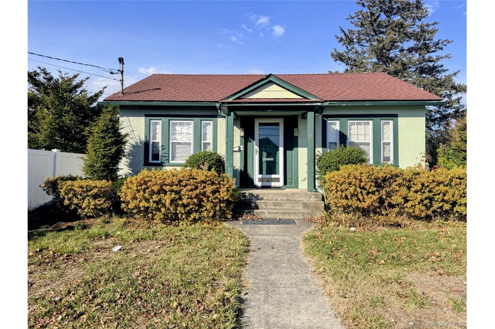 Bungalow-style home featuring stucco siding and a shingled roof