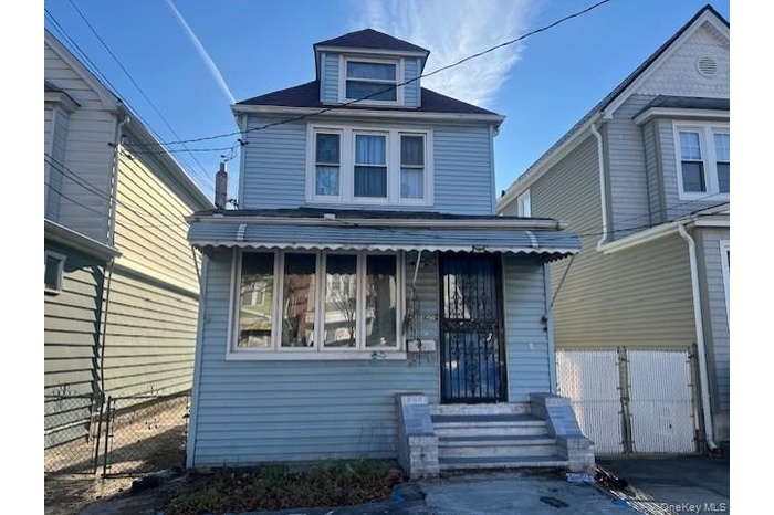 View of front of property with a gate