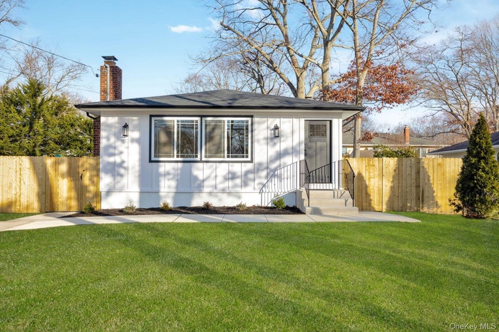View of front of property with a chimney and board and batten siding