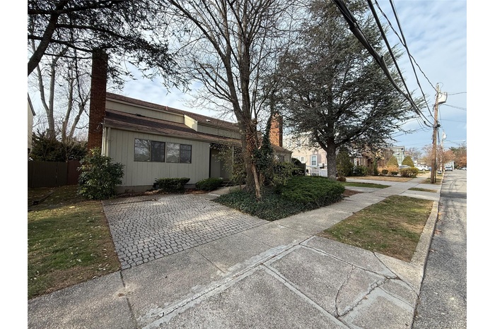 View of front facade featuring a chimney