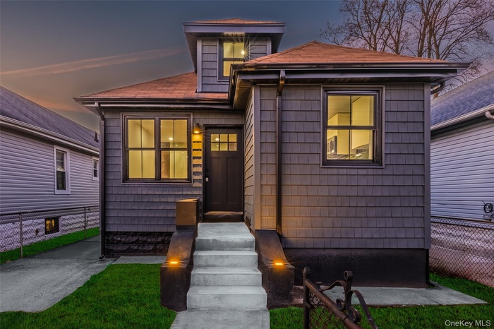 View of front of home featuring roof with shingles