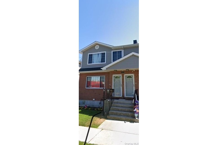 View of front of home featuring brick siding