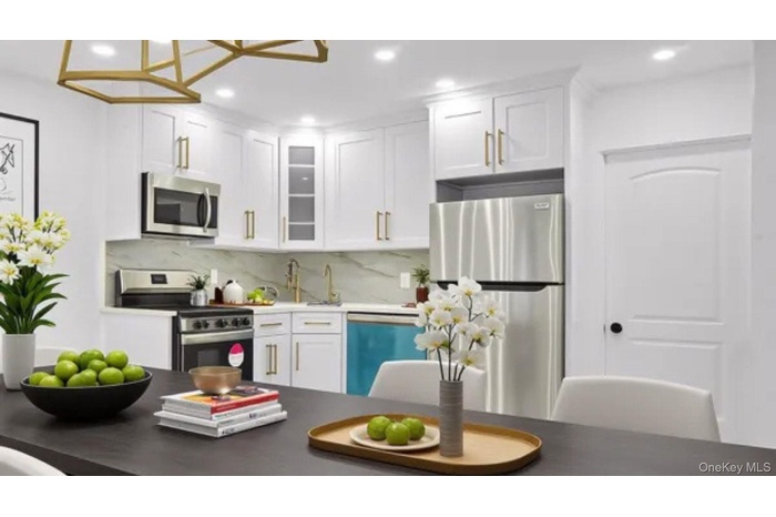 Kitchen featuring appliances with stainless steel finishes, white cabinetry, glass insert cabinets, recessed lighting, and dark countertops