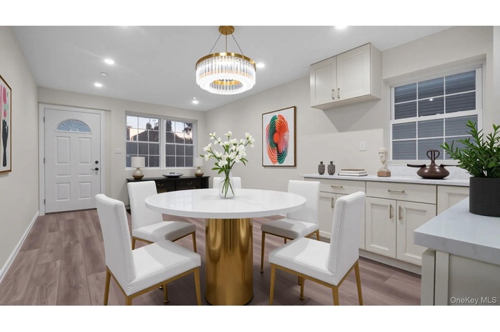 Dining room featuring light wood-style flooring, recessed lighting, and a chandelier