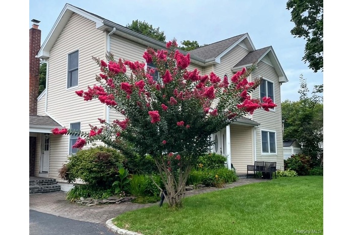 View of property exterior featuring a yard and a shingled roof