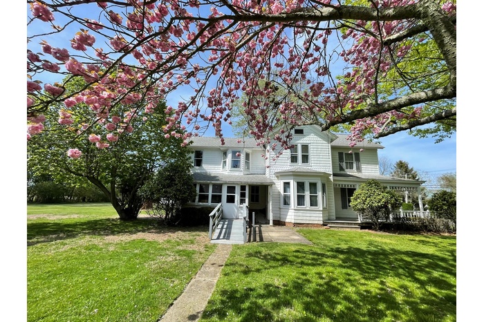 Rear view of house featuring a yard