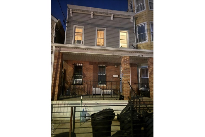 View of front facade featuring a porch and brick siding