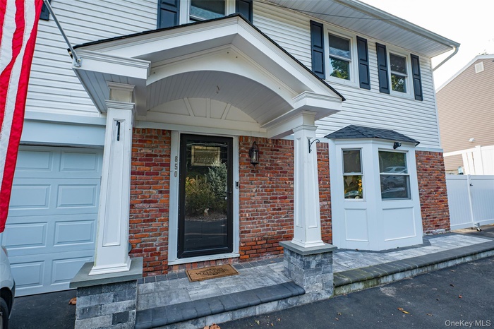 Property entrance featuring portico.