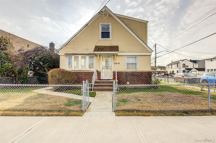 Front of home, brick siding, and a fenced front yard
