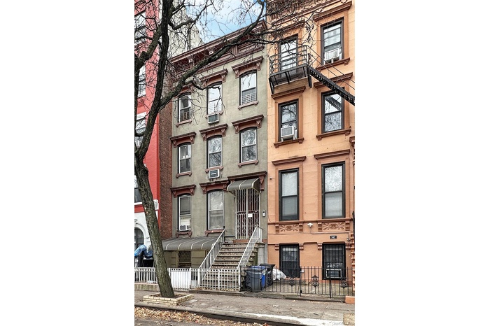 View of property featuring a fenced front yard