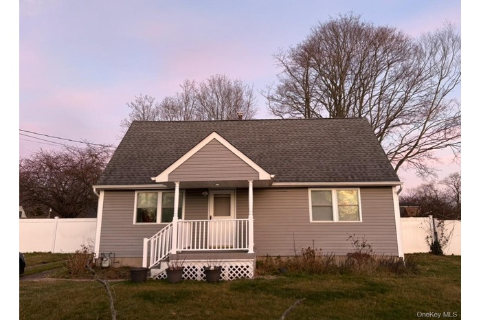 View of front of home with roof with shingles and covered porch