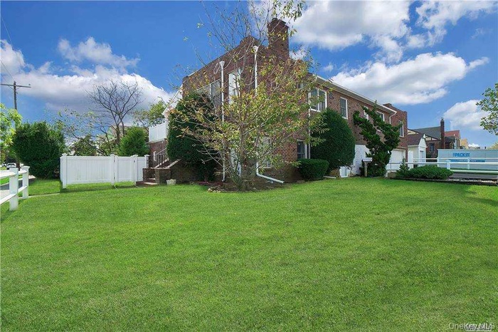 View of home's exterior featuring brick siding and a chimney