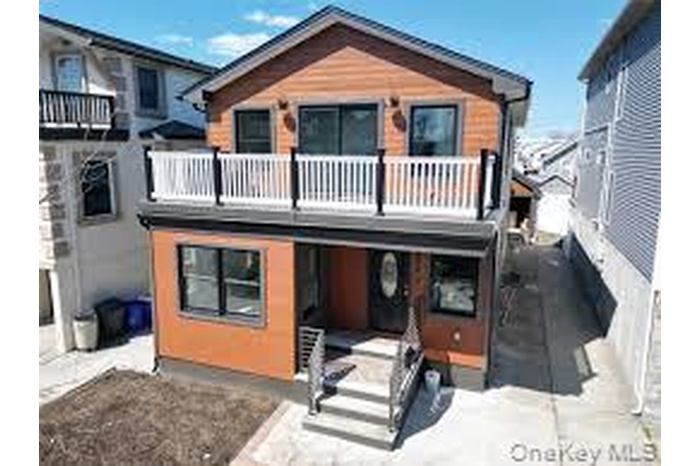 View of front facade featuring a balcony and a patio