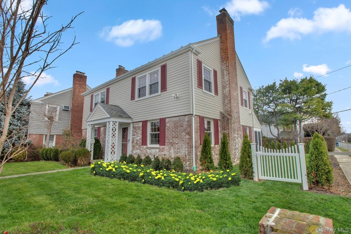 2 BAYVIEW COURT Colonial inspired home featuring a chimney and brick siding