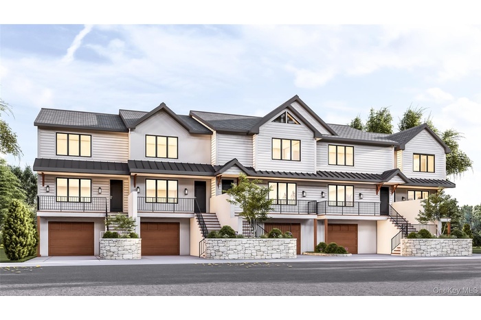 View of front of property with stairs, an attached garage, and stucco siding