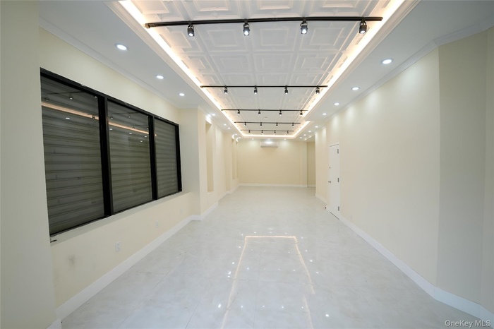 Corridor with rail lighting and recessed lighting