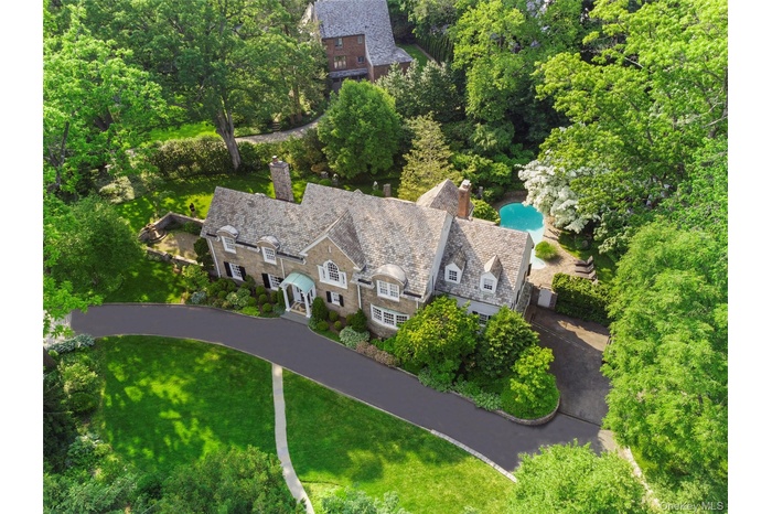 Aerial view of property and surrounding area with a pool area