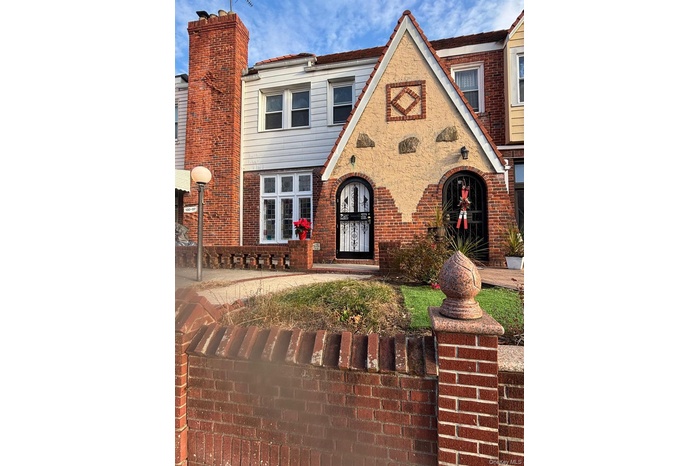 Tudor home with brick siding