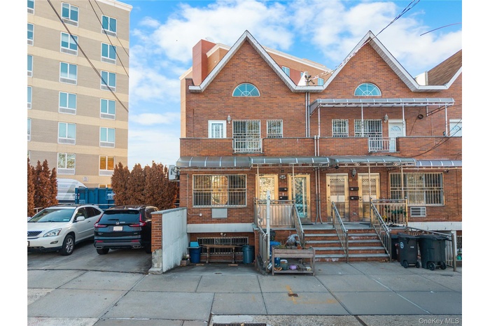 View of front facade featuring brick siding and a chimney