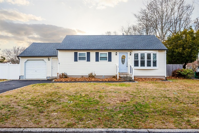 View of front of property with roof with shingles, driveway, a garage, and entry steps