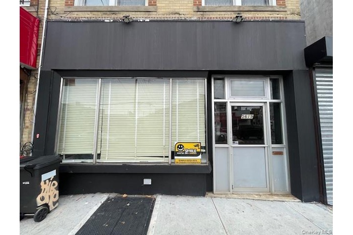 Property entrance featuring a sunroom and brick siding