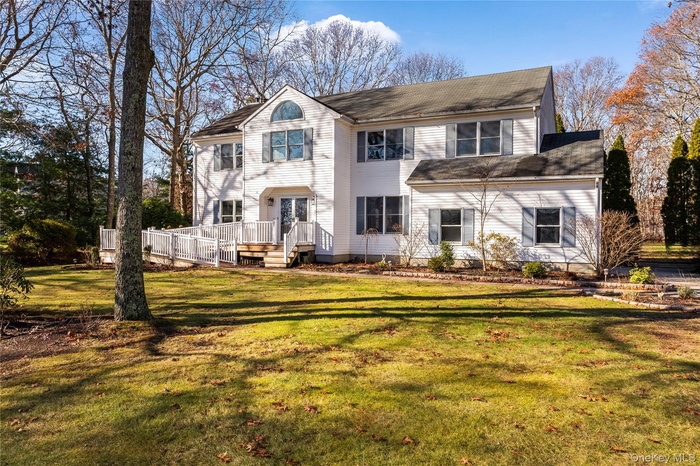 Traditional home featuring a front yard