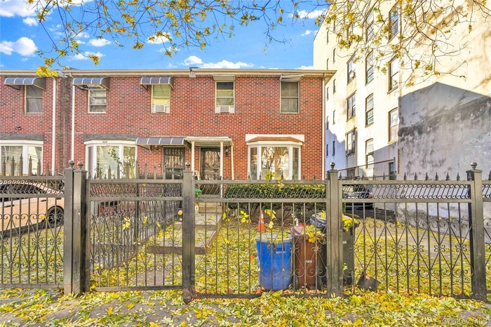 View of front of house featuring a fenced front yard and brick siding