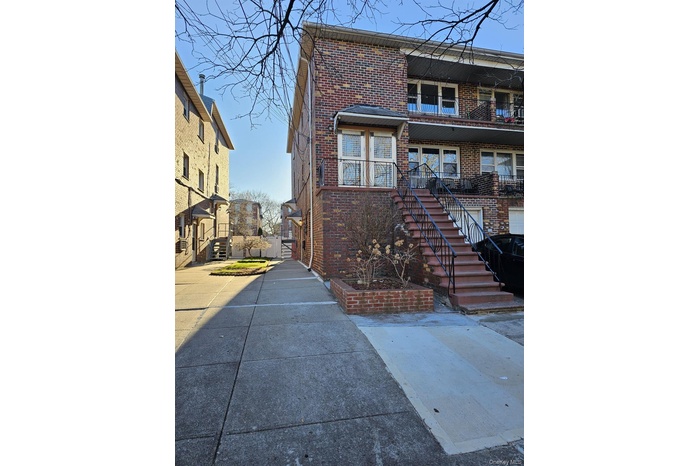 View of front facade with brick siding and stairway