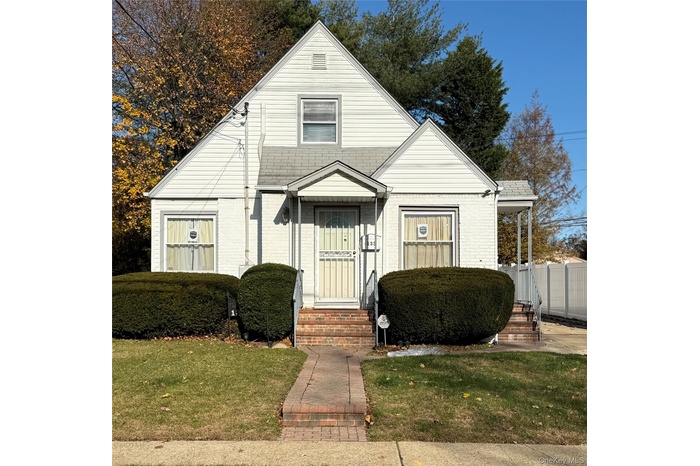 Bungalow-style home featuring entry steps and brick siding
