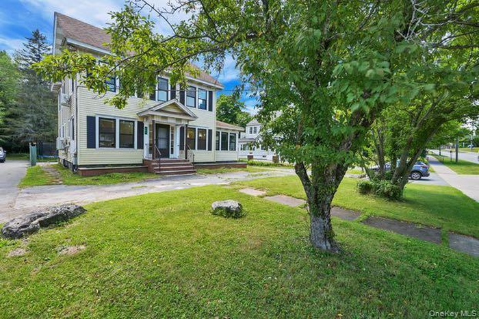 Colonial house featuring a front lawn