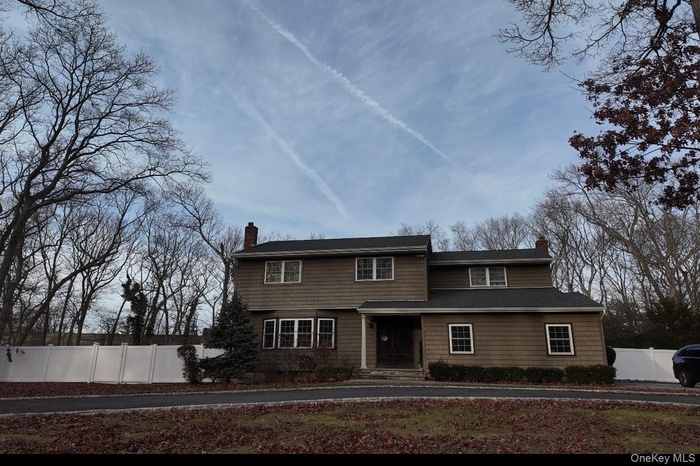 View of front facade featuring a chimney