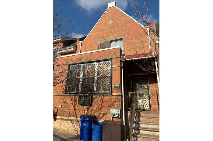 View of property exterior featuring brick siding