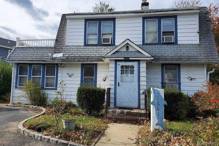 View of front facade featuring a chimney